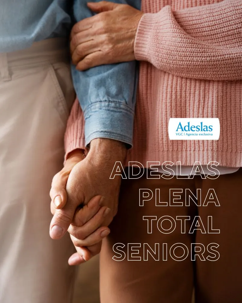 Pareja mayor cogida del brazo y de la mano con el sello Adeslas, imagen de un seguro de salud para mayores